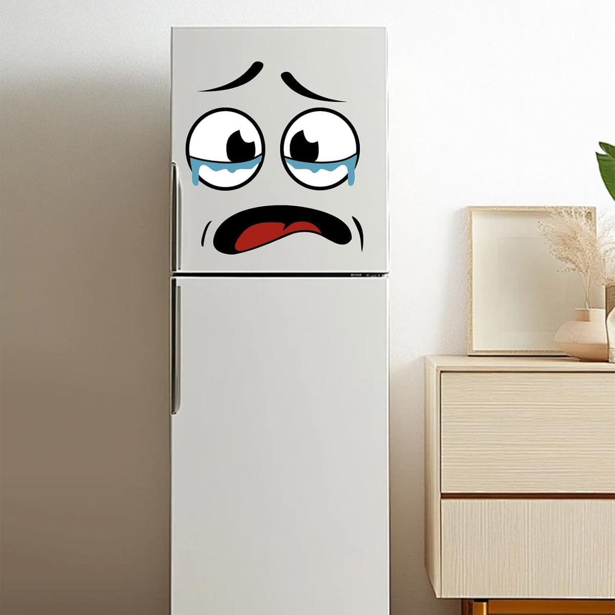 Crying face sticker stuck on a fridge door