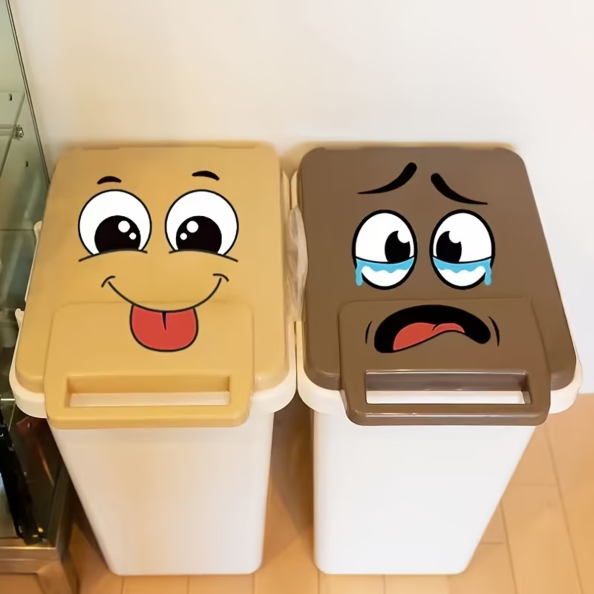 Four wheelie bin stickers with cartoon faces on grey bins
