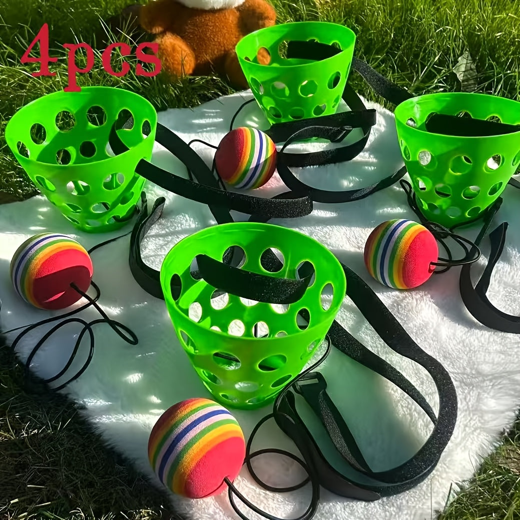 The four green baskets with balls on cords on a picnic blanket on the grass