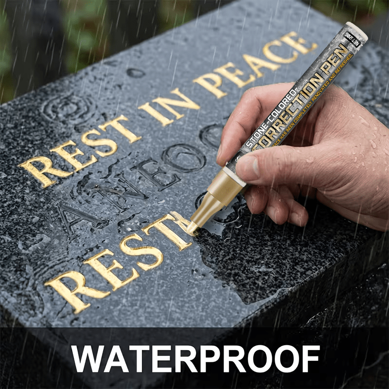 The gravestone pen restoring gilded text on wet stone